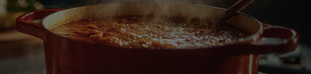 Still from Let It Simmer key art: a red pot simmering on a stove